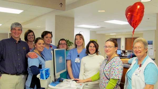 Gathered around a workstation on wheels at Southampton Memorial Hospital are, from left, Joe Martino, director of health information systems; nurses Ashlee Landrus, Mandy Cooke and Gretchen Scislowicz; Pam Wood, manager of acute and critical care services; Kristie Howell, director of information systems; and nurses Nikki Miller and Patsy Falls. -- SUBMITTED