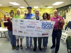 The Downtown Franklin Association team had the highest set score among the 19 teams competing in the Rotary Bowl-a-Thon. Team members Beverly Myers, left, Dan Howe, right, and Karry harrell, second from right, are congratulated by Bow-a-Thon Chairman Michael Clark, second from left, and Dr. Paul Conco, center, president of Paul D. Damp Community College, which sponsored the event. Also pictured is Bryce Perry, who rolled the highest individual set as a member of The Tidewater News team. -- SUBMITTED