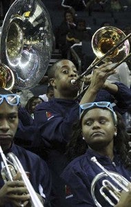 Thomas Councill III, center, plays the trombone during the Virginia State University versus St. Augustine College game at the Time Warner Cable Arena. -- FRANK A. DAVIS/TIDEWATER NEWS