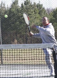 Southampton's Sam McDonald charges in preparation to hit the ball back over the net during Friday's match. -- FRANK DAVIS/TIDEWATER NEWS
