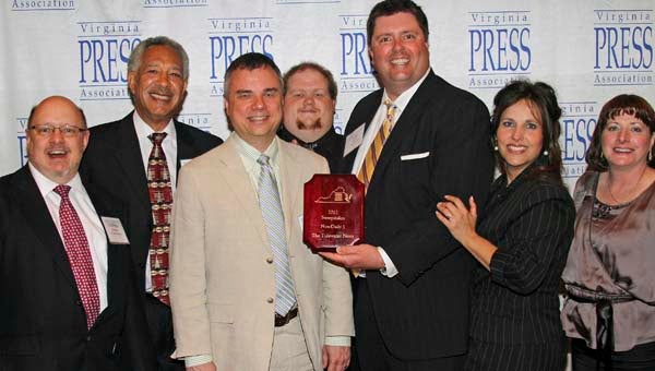 Stephen H. Cowles, left, Frank Davis, Publisher Steve Stewart, Ryan Outlaw, Associate Publisher Tony Clark, Advertising Director Mitzi Lusk and Kate Archer, all of The Tidewater News, show off the sweepstakes award the paper won Saturday night at the annual Virginia Press Association Awards ceremony in Norfolk. -- SUBMITTED/ALMETA DAVIS