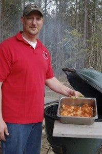 Henry Pulley shows off one of his specialties, Barbecue Chicken Thighs.