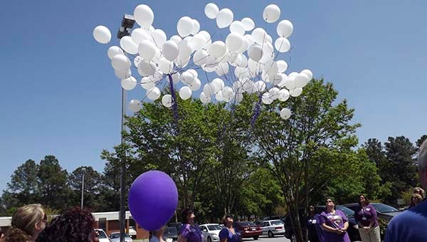 White balloons are launched at Southampton Memorial Hospital Friday to honor Sandy Joyner, former SMH employee, and her husband Joe. April 26 is the anniversary of the Joyners deaths and employees organized a walk in their honor. -- Submitted