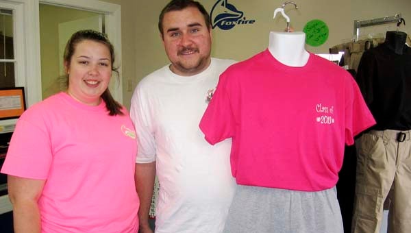 Jessica and Kevin Moore show off some of the clothing they offer at Moore Emergency Solutions, 222 Middle St., Franklin. In addition to everyday wear and uniforms for fire and rescue personnel, they also sell needed equipment. -- STEPHEN H. COWLES/TIDEWATER NEWS