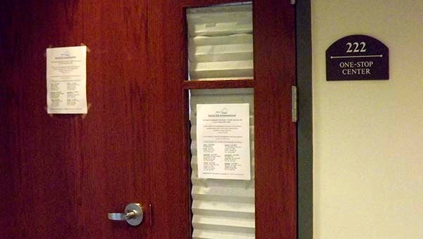 A flyer on the door of the Virginia Employment Commission office tells patrons the office is closed and where to get assistance with claims. -- LUCY WALLACE/TIDEWATER NEWS