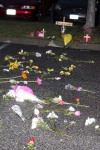 Flowers for Savannah Scheil were left in the Windsor High School parking lot. -- MATTHEW A. WARD/SUFFOLK NEWS-HERALD