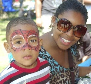 Jasiah Brown, 3, shows off his face paint as he stands beside his mother, Laquishia Rawls. They are from Carrsville. -- Merla Monahan | Tidewater News