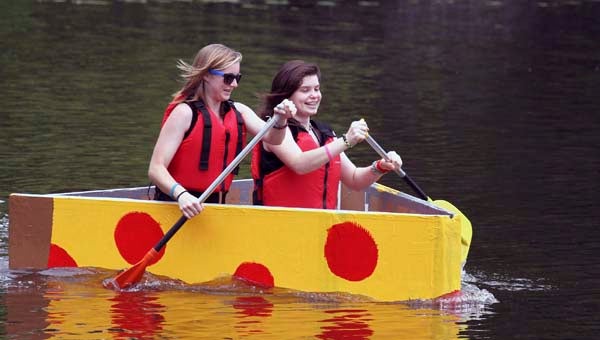 Cindy Mitrovic, left, and Madi Busby of the Franklin Robotics Team paddle Big Daddy Pizza to the victory on Saturday. The girls’ boat, sponsored by Joe’s Pizza and Pasta, came in first at the annual Robo-Regatta on Saturday at Barrett’s Landing in downtown Franklin. -- FRANK DAVIS/TIDEWATER NEWS