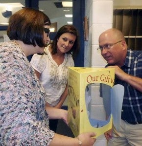 Meherrin Elementary School teacher Amy Hinson, left, shows the butterflies in the box to Jenny Hutto and Jim Yarborough, both of International Paper, Franklin Mill. The company’s foundation annually provides the supplies to the school. -- Stephen H. Cowles | Tidewater News