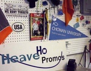 A bulletin board in the shop of Heave Ho Promos shows just a small portion of some of the items clients can get with logos. -- Lucy Wallace | Tidewater News