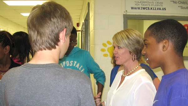 Deborah Evans, right, talks with some of her former students at Windsor Middle School. The sixth-grade teacher was recently named teacher of the year at that location and overall on the secondary level. -- Stephen H. Cowles | Tidewater News