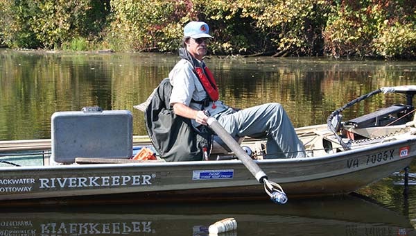 Blackwater and Nottoway Riverkeeper Jeff Turner is shown here picking up trash during one of his excursions on the water. He has been recognized in the June issue of Field & Stream magazine as a Hero of Conservation and was awarded a $500 grant from Toyota. -- Submitted
