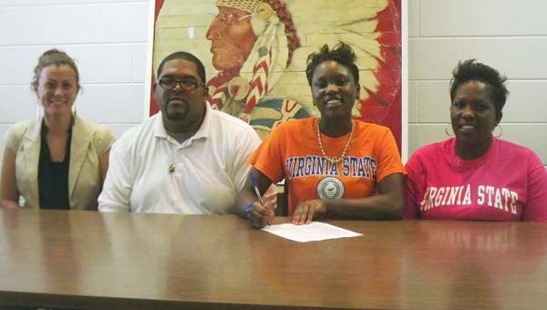 Southampton High School softball star DeMone’ Brickhouse signing her letter of intent to play college softball for Virginia State University.  The Indians’ MVP was offered a full scholarship to play for VSU.  Pictured are, from left to right:  Susan Melbye, SHS head softball coach, Brickhouse’s father Timmy Jones, Sr., Brickhouse, and mother Angela Jones. -- TONY CLARK/TIDEWATER NEWS