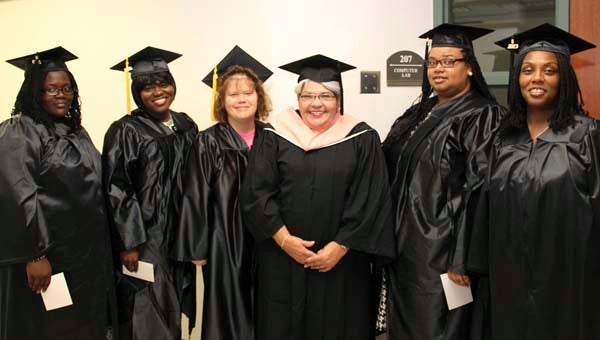 At her last graduation before retirement, Martha Kello joins some of her students for a photo. From left: Kimberly Jackson, Capria Jones, Michelle Van Ness, Kello, Crystal Bellamy and Cynthia Demiel. -- SUBMITTED