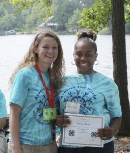 Diamond Warren of Southampton County, right, receives an award for her helpfulness and leadership from new 4-H agent Celia Brockway. -- SUBMITTED