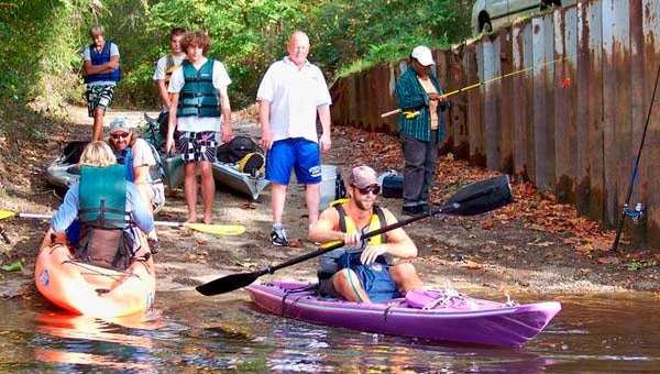 This picture, taken several years ago, show Marshall Rabil, in the purple kayak, as he waits for the people with him. Behind is Dr. Mercer Neale, headmaster at Southampton Academy. The late Barry Nolf, left, readies to push a student into the water. The three others behind them are more academy students, who were then part of an outdoor expedition club, which Toni Nolf said is how the river tours got started. -- SUBMITTED/TONI NOLF
