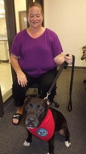 Carol Drewry of Franklin with Chunk, a pit bull trained and certified as a Therapy Dog. Drewry's already taken him to visit residents in area nursing homes, and wants to do much more with him. -- Stephen Cowles | Tidewater News