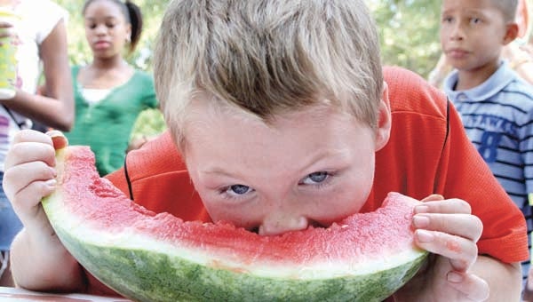 This child gets a nose full of watermelon as he participates one of several contests held at the 2012 North Carolina Watermelon Festival in Murfreesboro. The 2013 event, which marks the event’s 28th year, got under way on Wednesday. -- SUBMITTED/CAL BRYANT