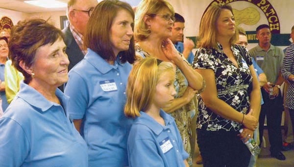 In the foreground, Jane Riddick, left, with one of her daughters, Alice Shaffer, and granddaughter, Erika, listen to a guest speaker for the 40th anniversary celebration of The Peanut Patch. -- STEPHEN H. COWLES | TIDEWATER NEWS