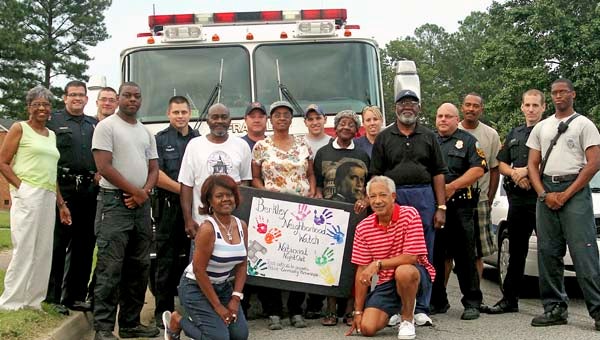 Franklin Police Officers, Franklin Fire and Rescue members and members of the Berkley Neighborhood Watch pose for a picture on National Night Out on Gardner Street. -- CAIN MADDEN | TIDEWATER NEWS