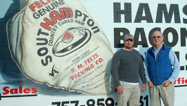 Robbie Felts, left, and his father, Bob Felts, outside the packing plant in Ivor. The family-owned business is among 13 nominees for the 2013 Tayloe-Murphy Resilience Awards. -- FILE PHOTO