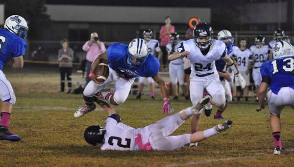 Tonee Hill (11) is tripped up after a gain. -- JIM HART | TIDEWATER NEWS