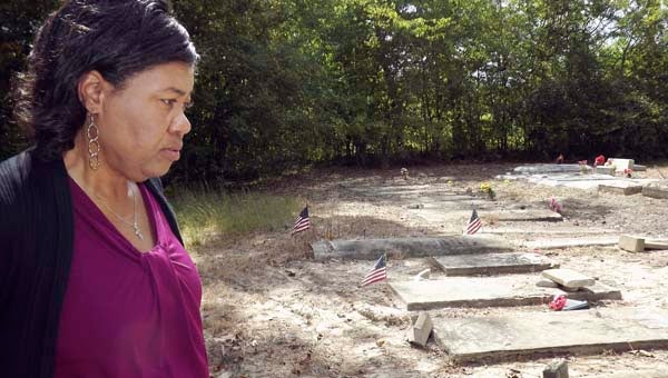 Mindy Purvis surveys the damage that a person or persons did to many of the markers at the Butts Family Cemetery in Sebrell. She discovered the vandalism Sunday when she went to visit her mother’s grave, which was undisturbed. -- STEPHEN H. COWLES | TIDEWATER NEWS