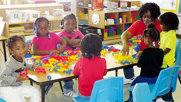 Mary Williams, right, works with children in the Head Start program at the new site in Courtland. "I like to be the foundation in their lives," she said. "You'll see how it pays off after they're older." -- STEPHEN H. COWLES | TIDEWATER NEWS