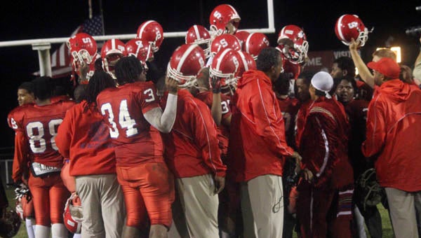 The Southampton Indians hold their helmets high after winning their first game of the season. -- CAIN MADDEN | TIDEWATER NEWS