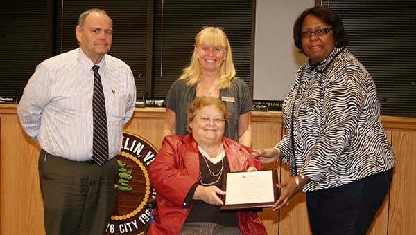 Presenting the resolution of honor and appreciation to Barbara Mease, seated, are Franklin Vice Mayor Barry Cheatham, Rosalind Cutchins and Mayor Raystine D. Johnson-Ashburn -- Frank Davis | Tidewater News
