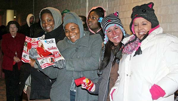 Happy Shoppers with sale flyers and gift tickets await the opening of the Belk department store in Franklin on Black Thursday. From left are Makeshia Sykes, Tralane Barham, Jaime Daughtery and Liz Mullins. -- FRANK A. DAVIS | TIDEWATER NEWS