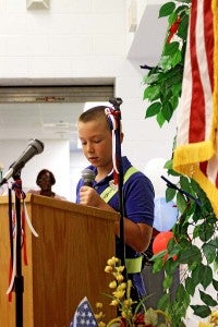 Meherrin Elementary student Josh Williams reads a poem in honor of Veterans Day. -- Cain Madden | Tidewater News