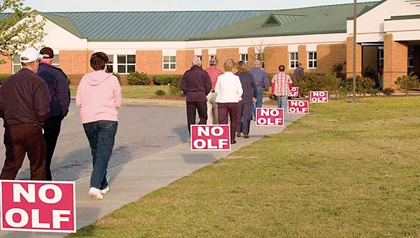 Citizens of Southampton, Sussex, Surry and Greensville counties filed past “NO OLF” signs while entering Southampton High School six years ago. The Navy has cancelled its Draft Environmental Impact Statement for an OLF in the area Tuesday. -- FIILE PHOTO