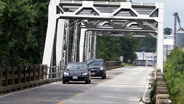 Two motorists drive across the Nottway River bridge on Route 35 outside Courtland. The bridge is expected to close Dec. 1, 2014, with construction following. -- FILE PHOTO