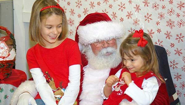 Loren and Ashlyn Keech talk to Santa. -- MERLE MONAHAN | TIDEWATER NEWS
