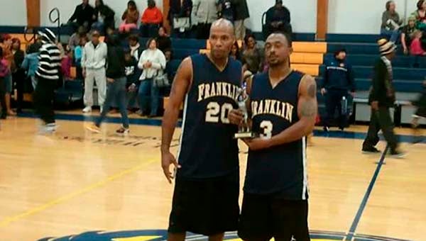 Two Franklin alumni players hold up a victory trophy -- SUBMITTED