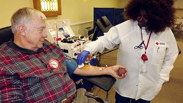 Takeysha Jackson of the Red Cross monitors the syringe in Bob Luck’s arm. His donation on Tuesday in First Baptist Church on High Street completed his 25th gallon. The 76-year-old has donated blood since the 1960s. -- STEPHEN H. COWLES | TIDEWATER NEWS