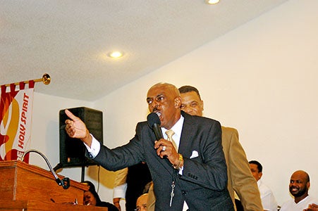 Pastor Elbert Louis of Mission of Deliverance Church delivers sermon.