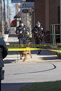 Police follow the bloodhound as it follows the scent toward Franklin Street. Photo by Cain Madden