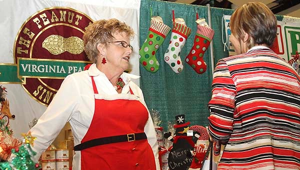 Nancy Brock, assistant manager at The Peanut Patch gift shop, talks to Lois Darden of Franklin about the store during the business expo this past November. The Courtland-based company, which includes FERIDIES, will again attend the Winter Fancy Food Show in San Francisco this weekend. -- FILE PHOTO