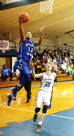 Tonee Hill drives to the basket in the first quarter. Photo by FRANK DAVIS