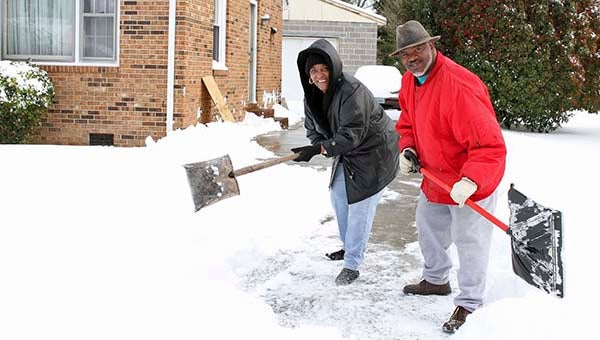 Willis & Diann Moody shoveling snow -- Frank Davis | Tidewater News