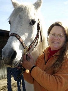 Sweetie with Belinda Taylor at the farm on Buckhorn Quarter Road. Taylor is working to create a sanctuary for horses that need rescuing. She’s seeking volunteers as well as financial aid. -- STEPHEN H. COWLES | TIDEWATER NEWS