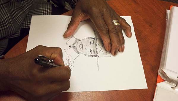 Thomas Murphy sketches out a portrait. -- STEPHEN H. COWLES | TIDEWATER NEWS