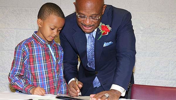 Justin Preau, 8, after it was all over for the breakfast, came forth and requested an autograph of Willie E. Gary. Justin is in the second grade at Southampton Academy. He is the son of Natasha and Ross Preau. -- FRANK DAVIS | TIDEWATER NEWS