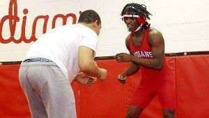 Devine Fenner, in red, practices with Sam McDonald before the state tournament. Fenner placed fourth in his weight class. --CAIN MADDEN | TIDEWATER NEWS