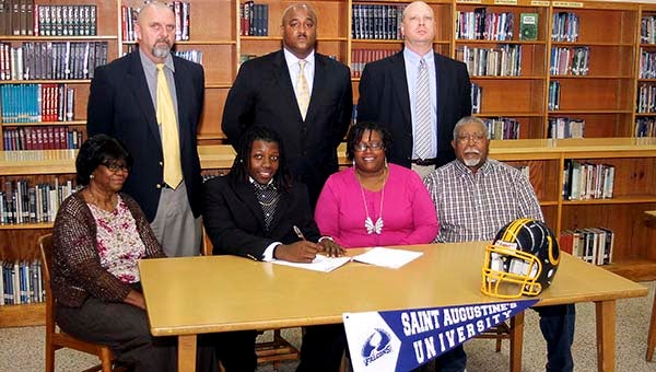 Franklin High School’s Terry Warren II will play college football with Saint Augustine’s University in Raleigh, N.C. Top row, from left, Athletics Director Dave Lease, Head Football Coach Darren Parker, Principal Travis Felts; bottom row, from left, grandmother Marie Perkerson, Warren, 18, mother Cheryl Pinkney and grandfather Paul Perkerson. -- CAIN MADDEN | TIDEWATER NEWS