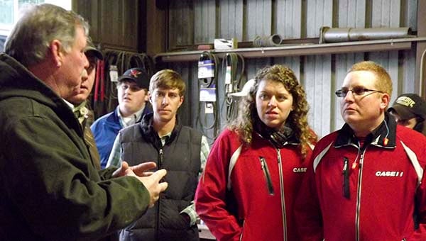 Billy Gwaltney, left, of Indika Farms in Windsor, talks about how peanuts are processed. In front, from left, are Ned Jeter II of Roanoke, and Melanie and Michael Fink of Pennsylvania. -- STEPHEN H. COWLES | TIDEWATER NEWS