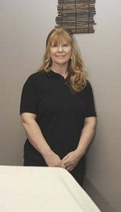 Paula Hatfield, owner of Kathara Spa in Courtland, stands beside a massage table. Swedish, deep tissue and Thai are a few styles she and Melissa Felton will offer. -- CAIN MADDEN | TIDEWATER NEWS