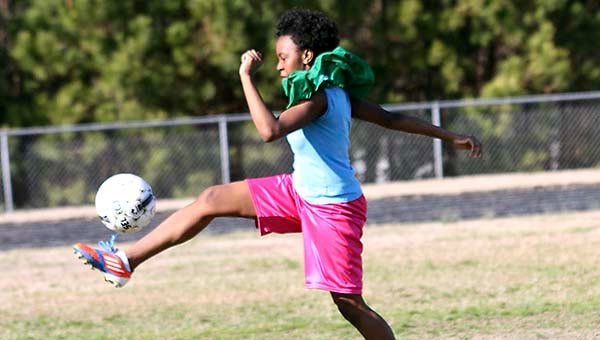 Latrina Cross, 15, intercepts a kick from the boys team during a practice. -- Cain Madden | Tidewater News